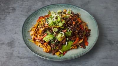 Pan fried flat noodle (fresh wheat noodle) in homemade spicy sauce